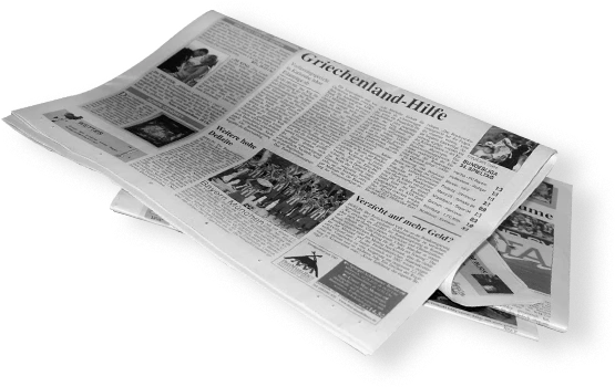 A folded newspaper displaying various articles and images on its pages.